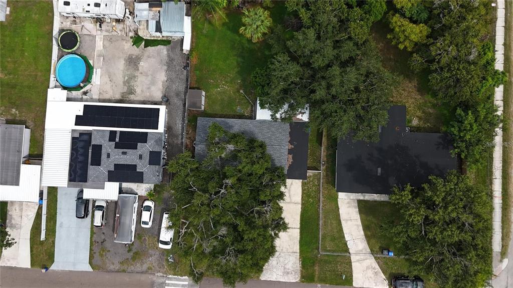 An aerial view shows three adjacent residential properties with driveways, trees, and a swimming pool — 9616 PINE RIDGE AVENUE, RIVERVIEW, FL