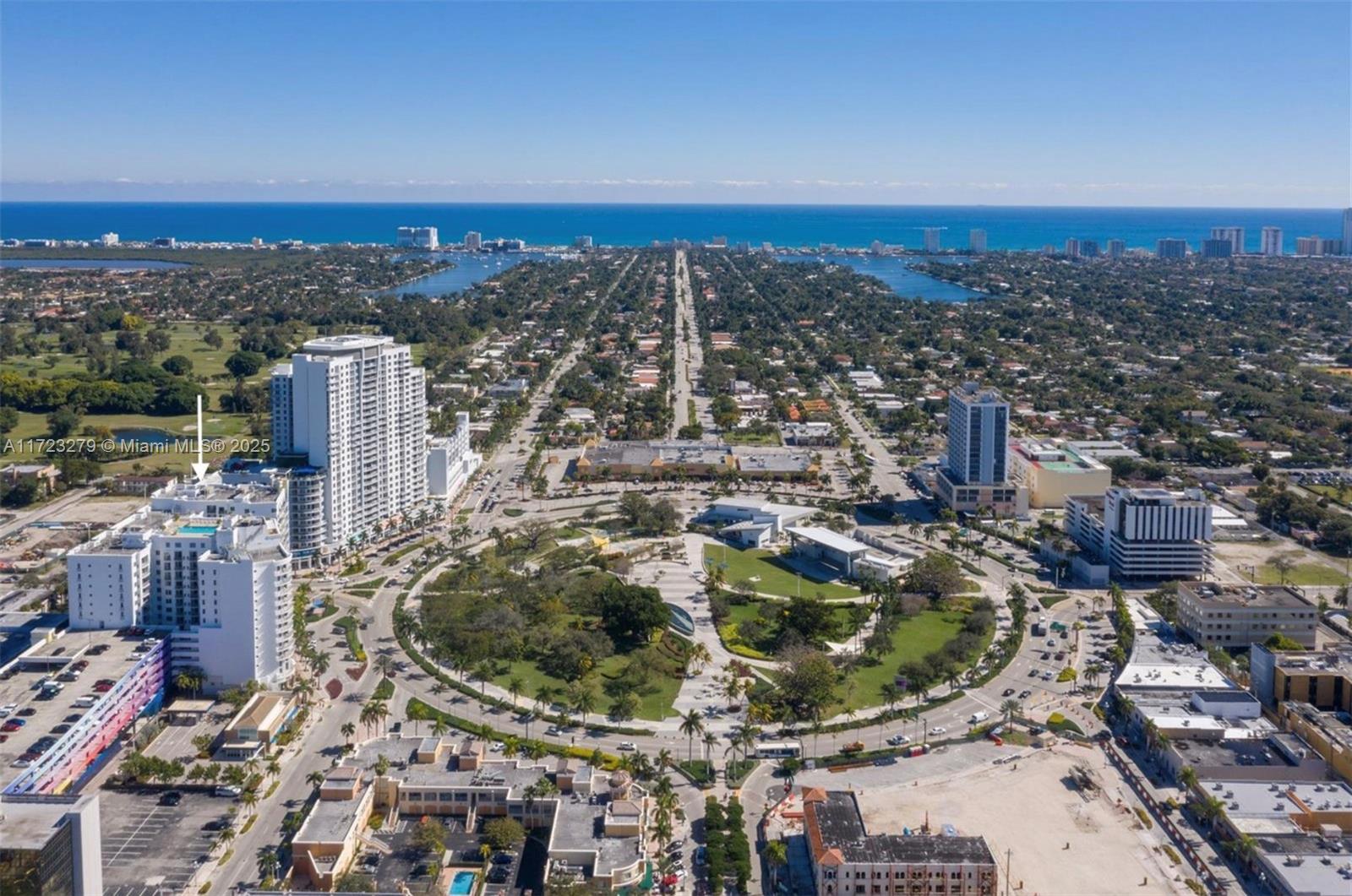 An aerial view shows a circular park surrounded by high-rise buildings and city streets — 1830 Radius Dr # 421, Hollywood FL 33020, HOLLYWOOD, FL