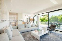 A modern living room features a large sectional sofa, a white coffee table, and floor-to-ceiling windows — 41 route des breguieres, CT 06110, CT