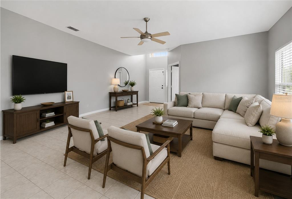 A living room features a sectional sofa, two armchairs, a television, and tile flooring — 2572 ACUNA COURT, LAKE MARY, FL