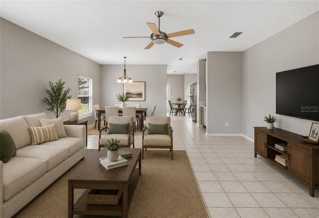 A living room and dining area with neutral walls, tile flooring, and wood furniture — 2572 ACUNA COURT, LAKE MARY, FL
