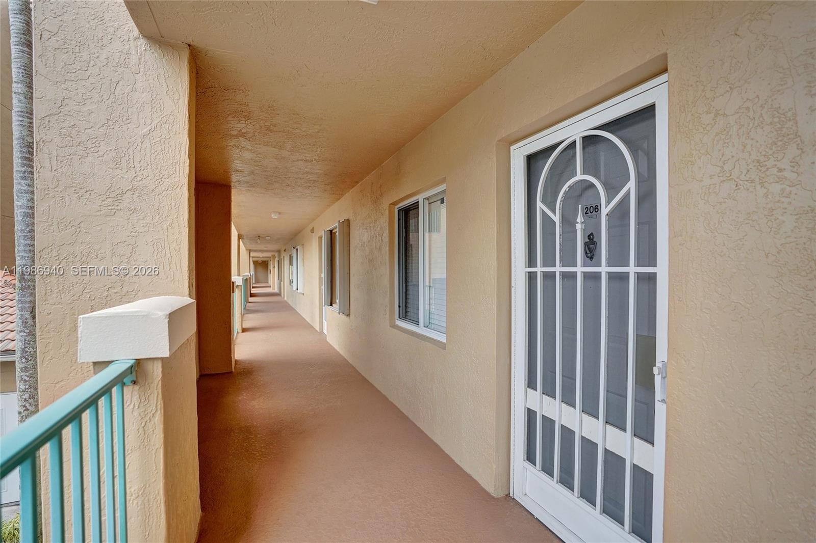 This lobby area features tile flooring, two armchairs, a wall of mailboxes, and an elevator — 12547 Imperial Isle Dr # 206, Boynton Beach FL 33437, BOYNTON BEACH, FL