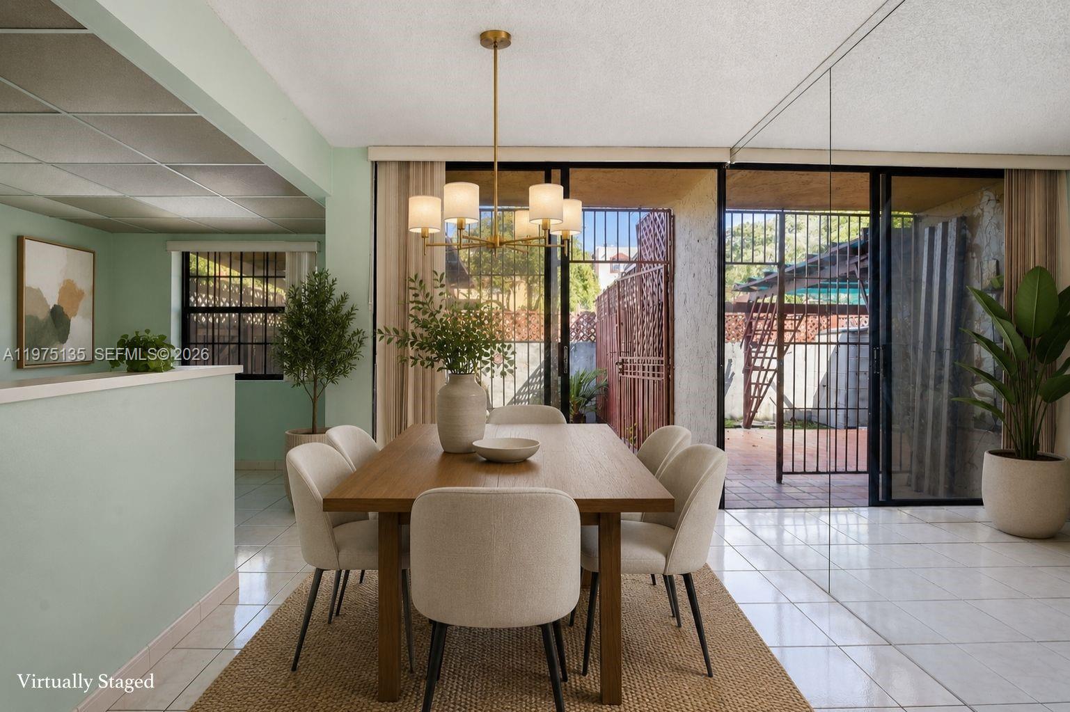 A dining room with a wooden table, six chairs, and sliding glass doors to a patio — 12253 SW 16th Ter # M, Miami FL 33175, MIAMI, FL