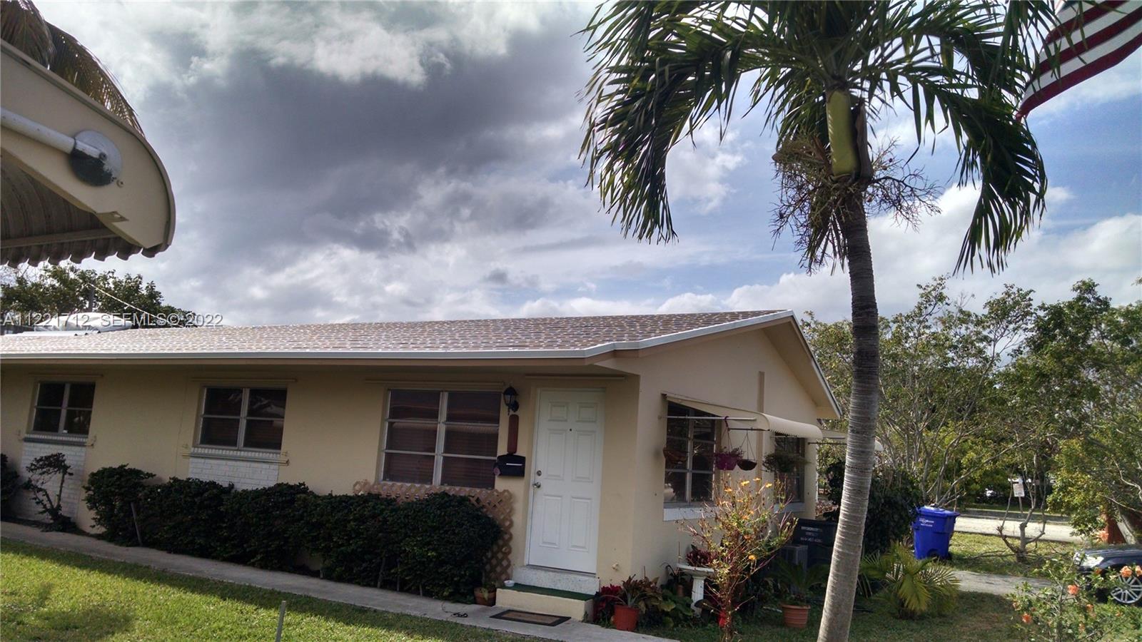 A one-story beige house with a palm tree in the front yard — 2212 Johnson St, Hollywood FL 33020, HOLLYWOOD, FL