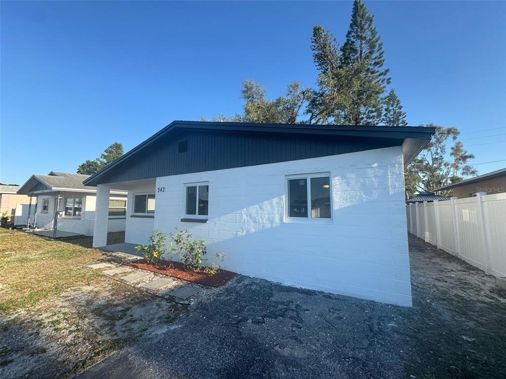A white concrete block house with a dark roof and a small front yard — 342 51ST AVENUE N, ST PETERSBURG, FL