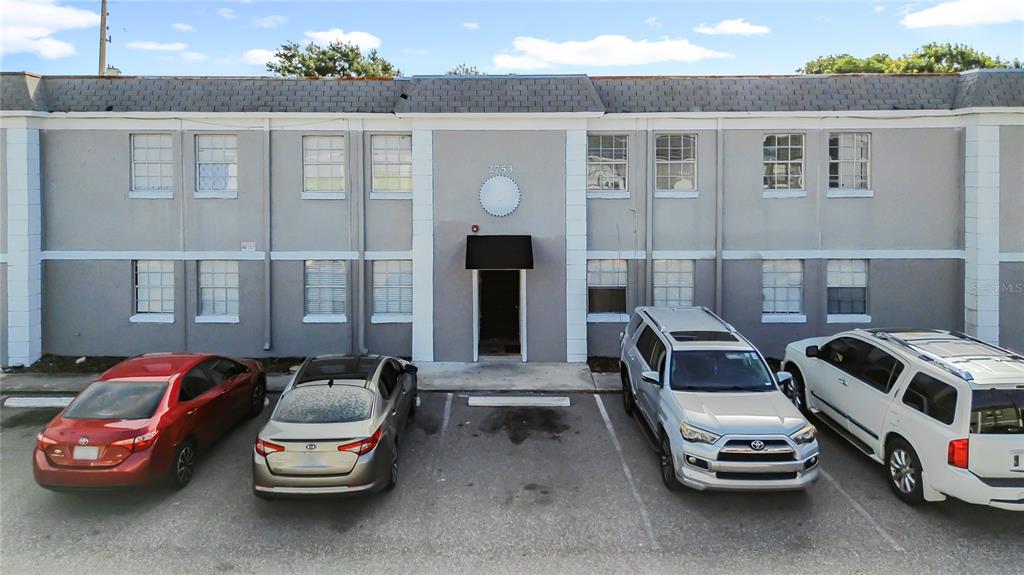 An exterior view of a two-story apartment building with four parked cars in front — 2753 L B MCLEOD ROAD UNIT D, ORLANDO, FL