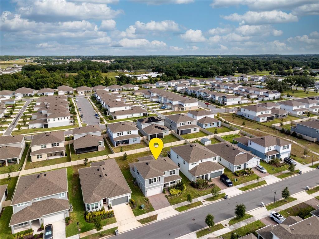 An aerial view shows a suburban neighborhood with a yellow location pin on a house — 3980 MEANDERING BAY DRIVE, APOPKA, FL
