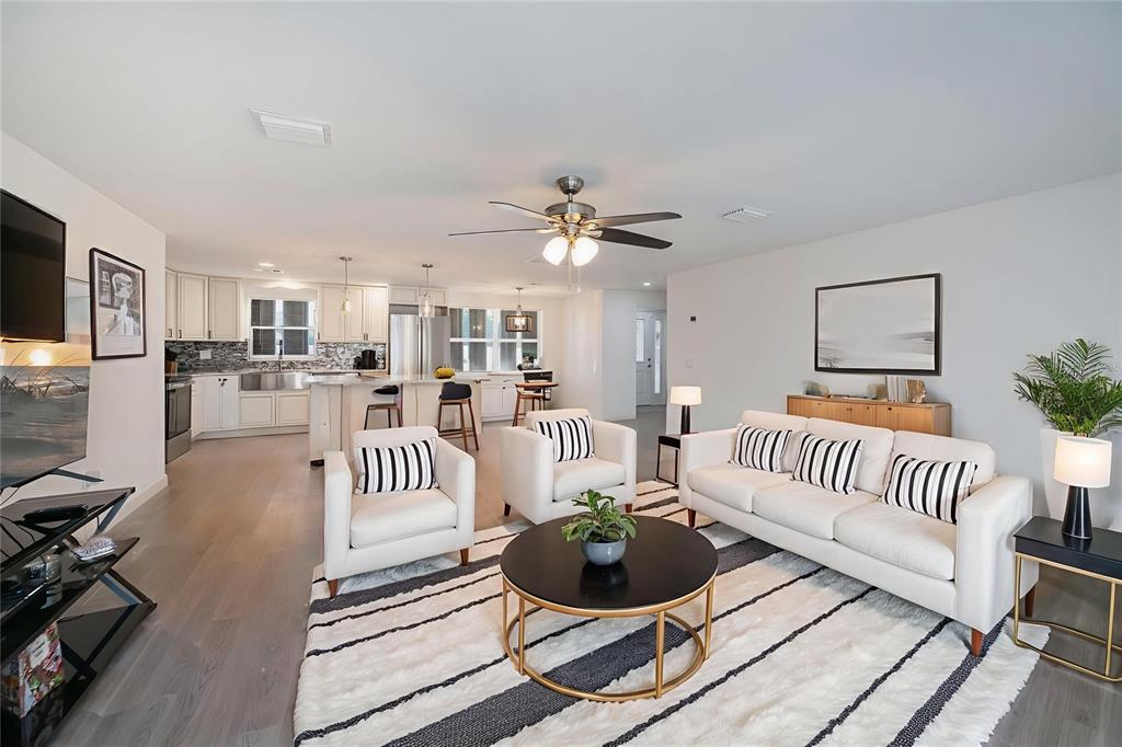 A backyard patio features a composite deck, a fire pit, and outdoor seating furniture — 2820 MARLIN PLACE, PUNTA GORDA, FL