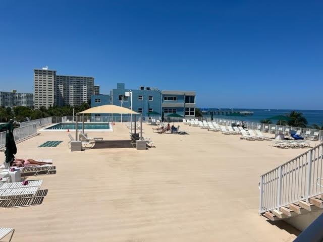A large, open-air pool deck features lounge chairs, a swimming pool, and ocean views — 101 Briny Avenue # 2505, Pompano Beach FL 33062, POMPANO BEACH, FL