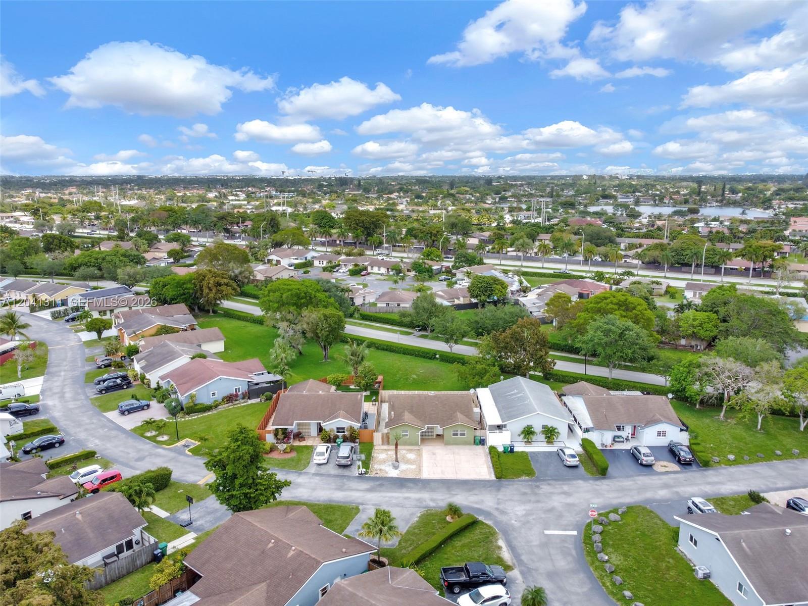 An aerial view shows a suburban neighborhood with single-family homes, paved streets, and green lawns — 4471 SW 138th Ct, Miami FL 33175, MIAMI, FL