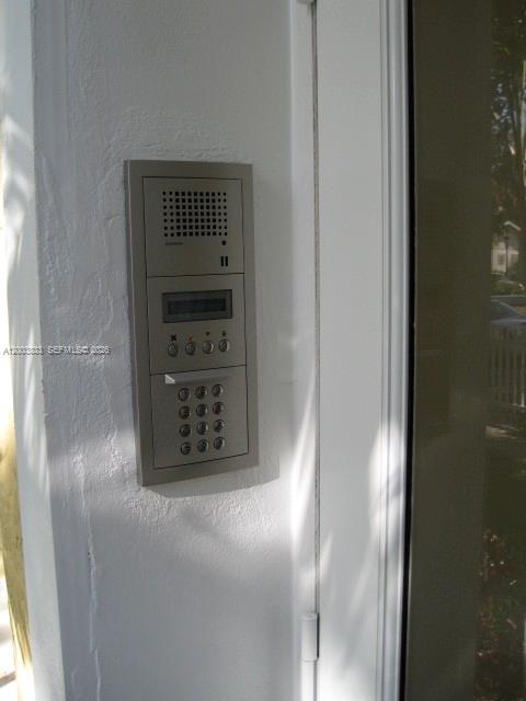 A silver intercom and keypad system is mounted on a white exterior wall — 843 SW 13th Ave # 202, Miami FL 33135, MIAMI, FL