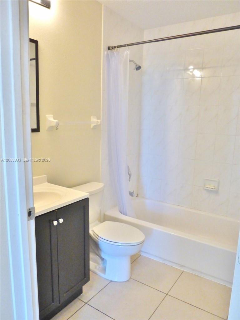 A bathroom features a dark vanity, a white toilet, and a shower-tub combination — 843 SW 13th Ave # 202, Miami FL 33135, MIAMI, FL
