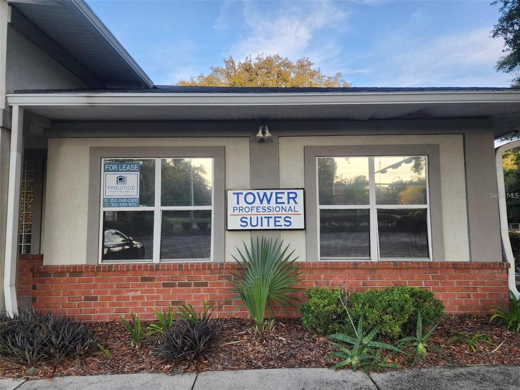 The exterior of a single-story commercial building features a brick base and a signage panel — 101 NW 75TH STREET UNIT Suite 1, GAINESVILLE, FL
