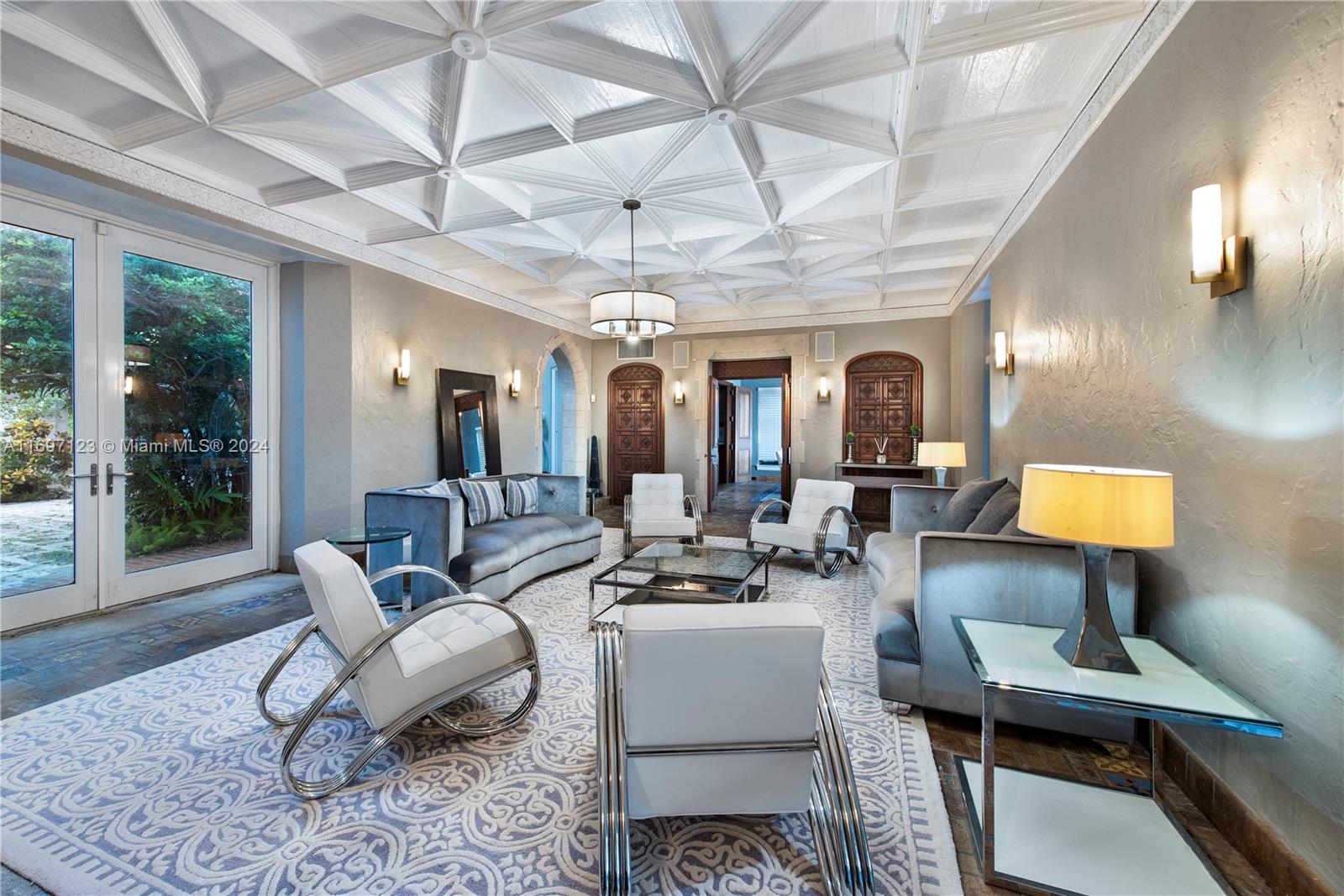 A living room features a geometric coffered ceiling, white leather chairs, and gray velvet sofas — 4745 Pine Tree Dr, Miami Beach FL 33140, MIAMI BEACH, FL