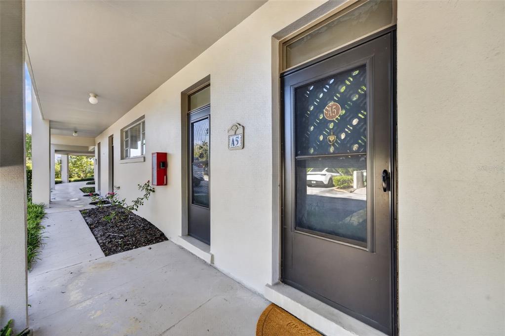 A covered outdoor walkway leads to the front door of a unit marked A5 — 700 MELROSE AVENUE UNIT A5, WINTER PARK, FL