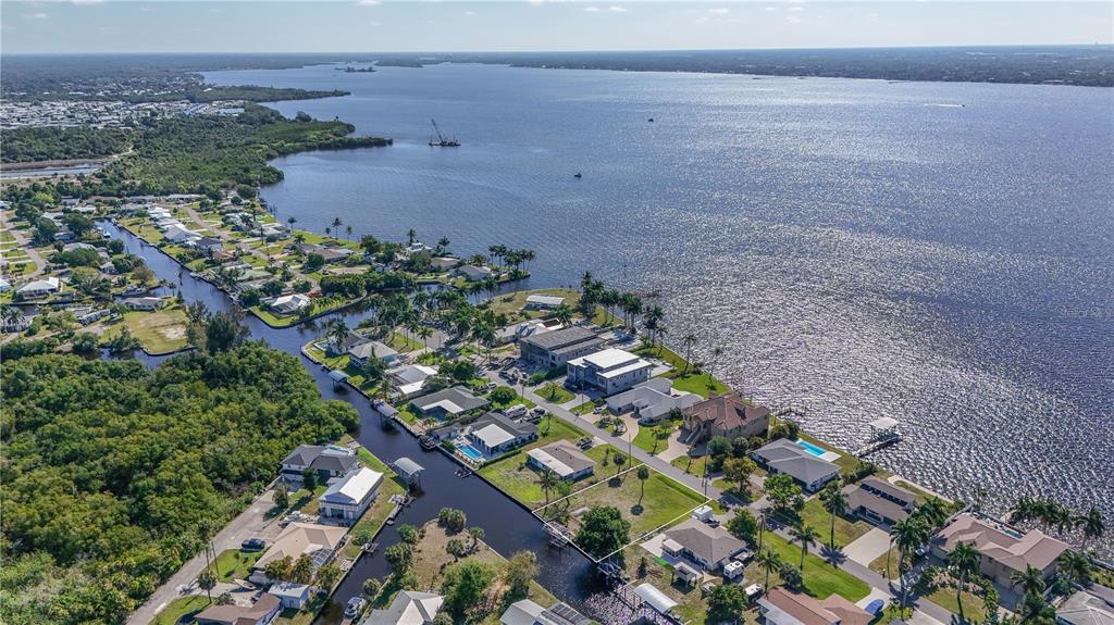An aerial view of a vacant waterfront lot situated between a canal and a river — 116 E NORTH SHORE AVENUE, NORTH FORT MYERS, FL