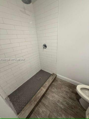 An empty room features white walls, a single window, and light-colored wood-look flooring — 5129 NW 5th Ave, Miami FL 33127, MIAMI, FL