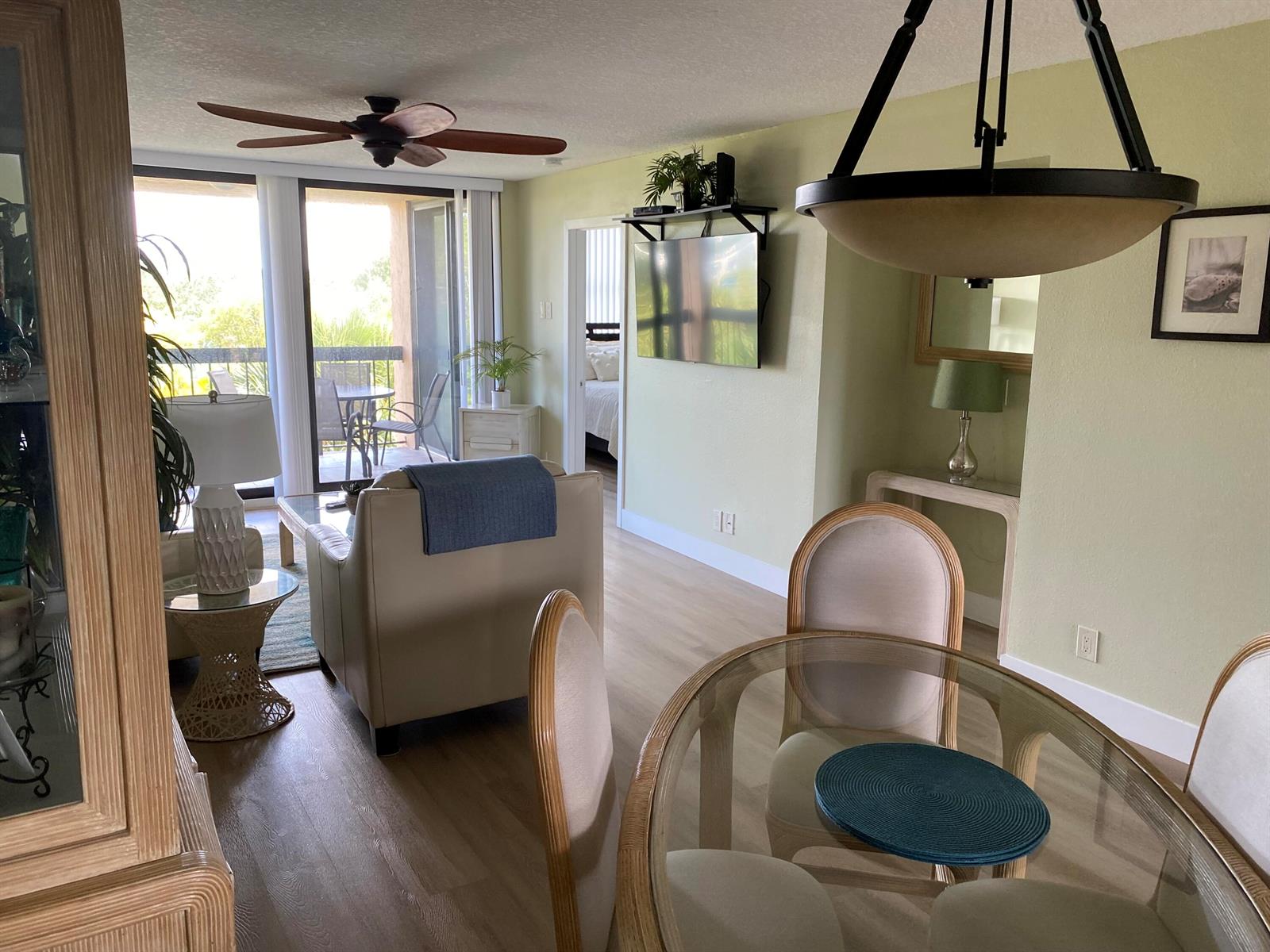 A living and dining area with a glass table, beige furniture, and a balcony view — 600 Egret Circle # 7401, Delray Beach FL 33444, DELRAY BEACH, FL