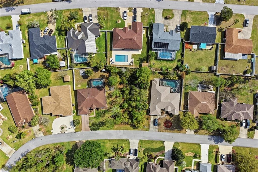 Aerial view of a suburban neighborhood featuring houses with swimming pools and landscaped yards — 95 FREEMONT, PALM COAST, FL