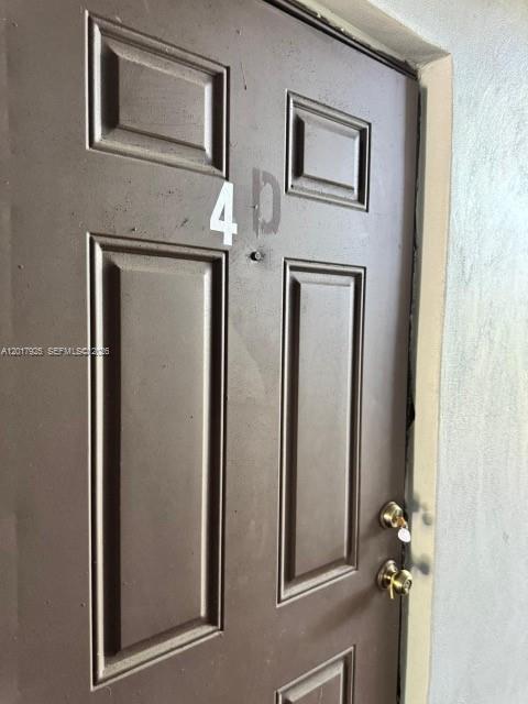 A brown door labeled 4D features a peephole and two gold-colored door locks — 380 E Laurel Dr # 4D, Margate FL 33063, MARGATE, FL