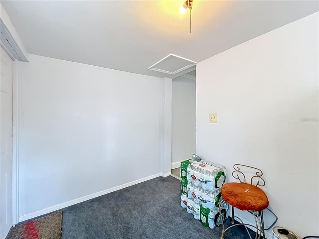 A small room with gray carpeting, white walls, a ceiling light, and a storage area — 1119 CYPRESS AVENUE, SANFORD, FL