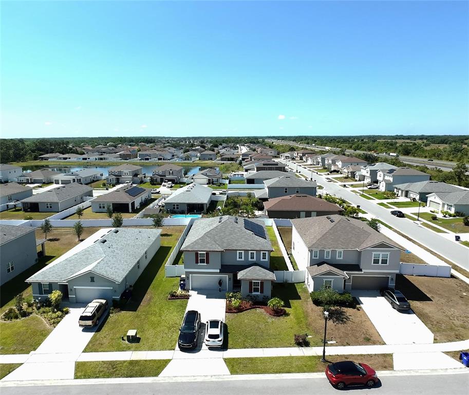 An aerial view shows suburban houses with driveways and lawns in a residential neighborhood — 3576 BRISTOL COVE LANE, ST CLOUD, FL