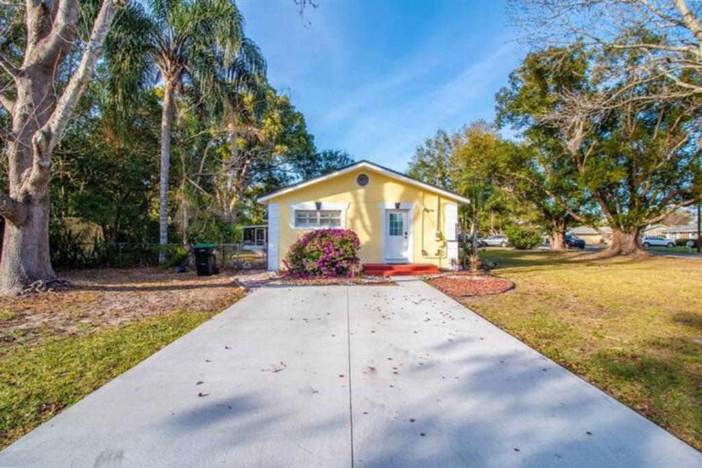 A yellow single-story house with a concrete driveway and a front door under a gable roof — 3120 PEEL AVENUE UNIT 2, ORLANDO, FL