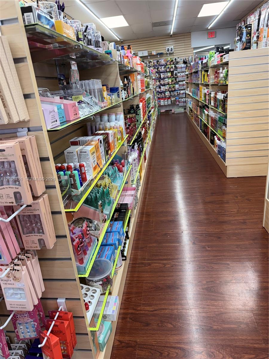 This retail store aisle features rows of shelves stocked with beauty products and hair care items — 715 NE 167th St, North Miami Beach FL 33162, NORTH MIAMI BEACH, FL