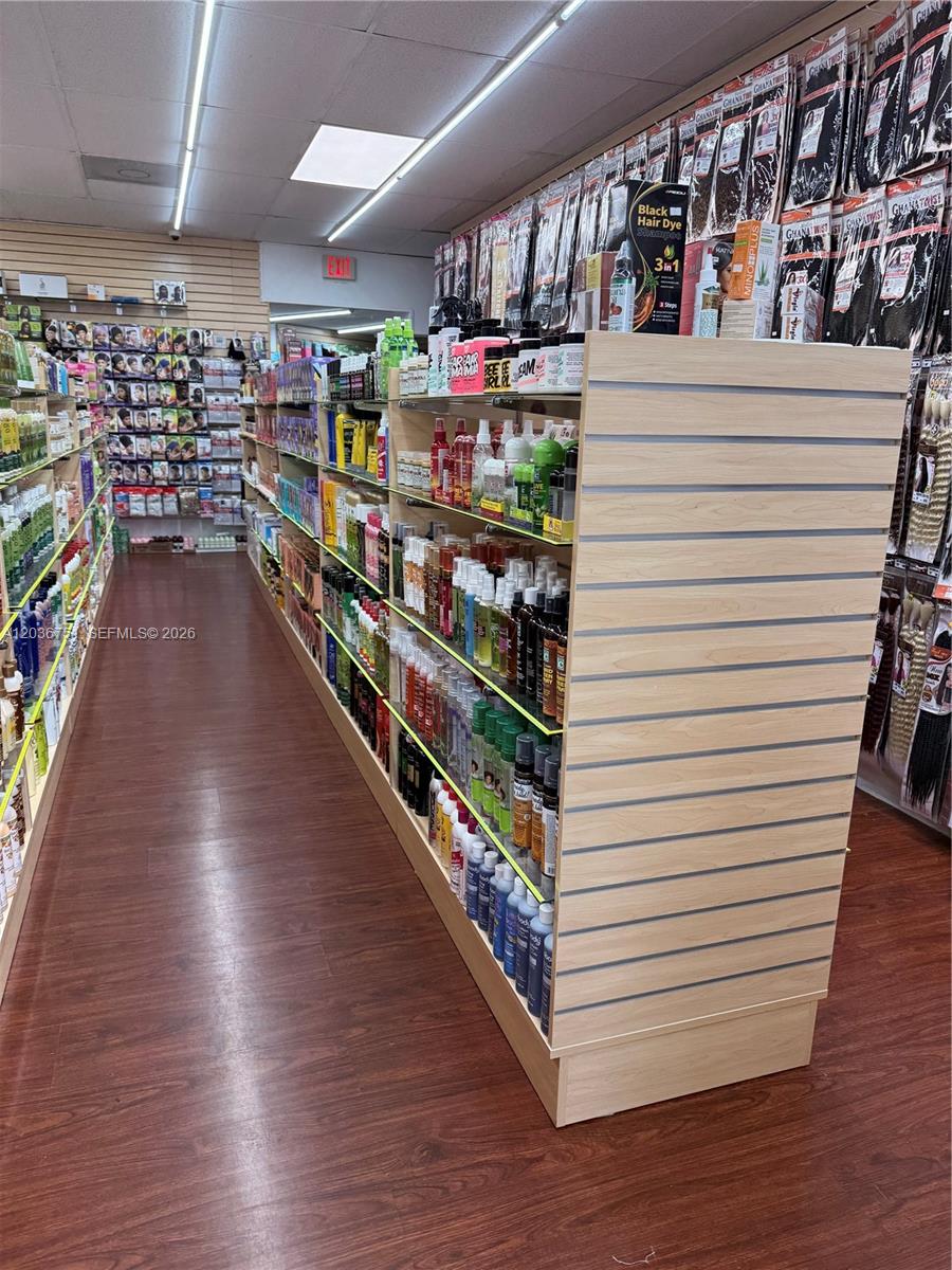 A retail store aisle features shelves stocked with hair care products and packaged hair extensions — 715 NE 167th St, North Miami Beach FL 33162, NORTH MIAMI BEACH, FL