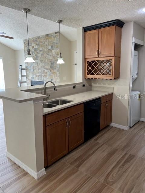A kitchen features wood cabinets, a wine rack, a stainless sink, and light-colored countertops — 662 YOUNGSTOWN PARKWAY UNIT 206, ALTAMONTE SPRINGS, FL