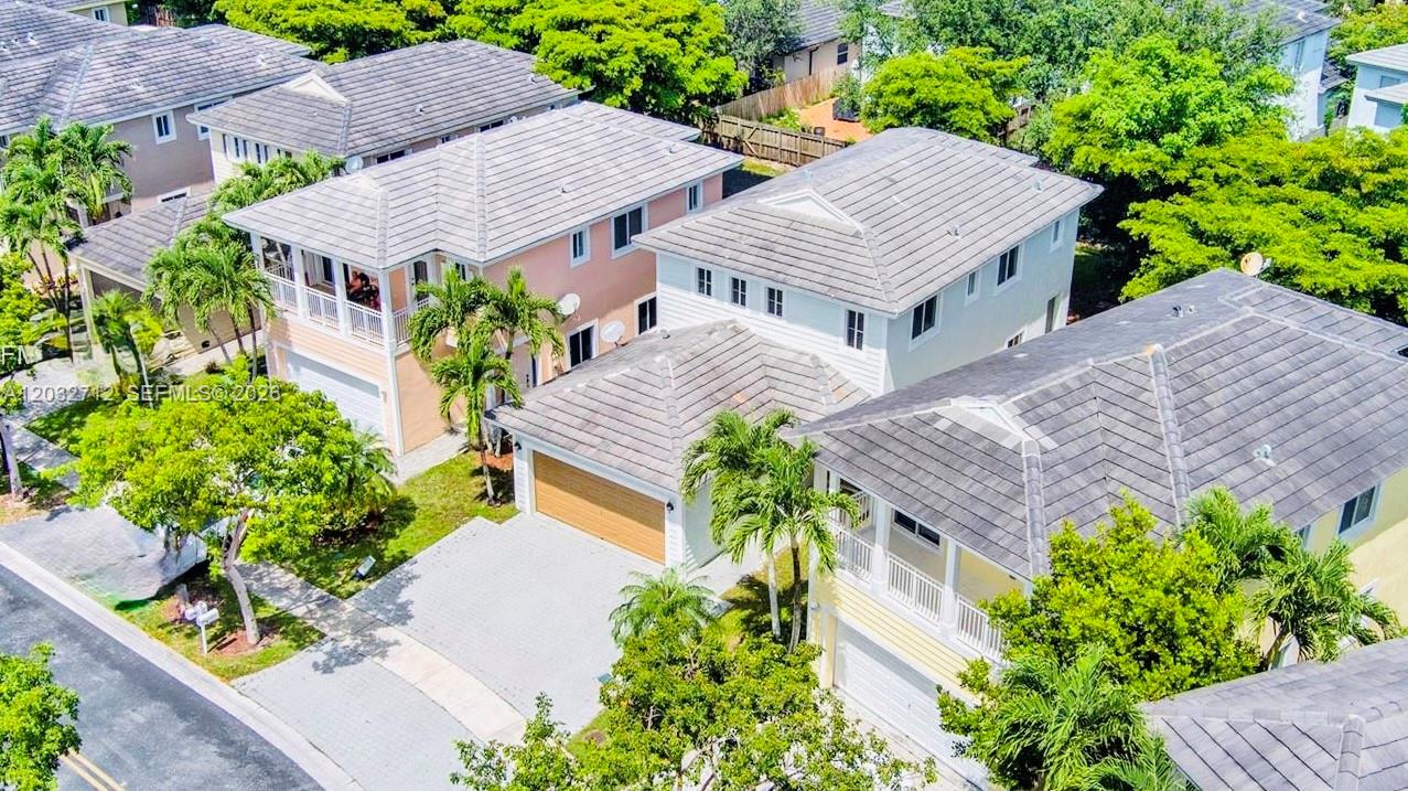An aerial view shows several two-story suburban houses with tiled roofs and attached garages — 363 NE 35th Ter, Homestead FL 33033, HOMESTEAD, FL