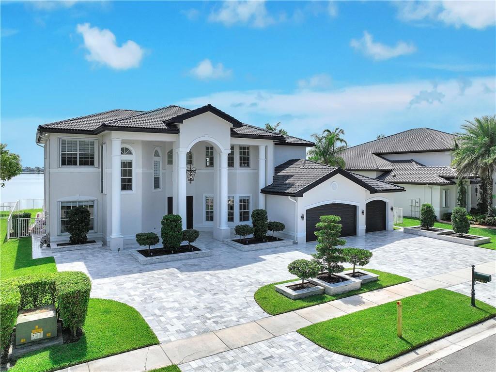 A two-story house with a white exterior, dark roof, and a paved driveway — 4707 SW 195th Terrace, Miramar FL 33029, MIRAMAR, FL