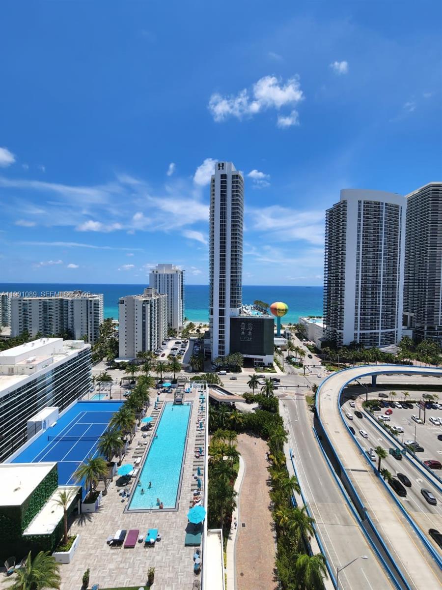 An elevated view shows a swimming pool, tennis court, high-rise buildings, and a coastal highway — 4010 S Ocean Dr # R1709, Hollywood FL 33019, HOLLYWOOD, FL