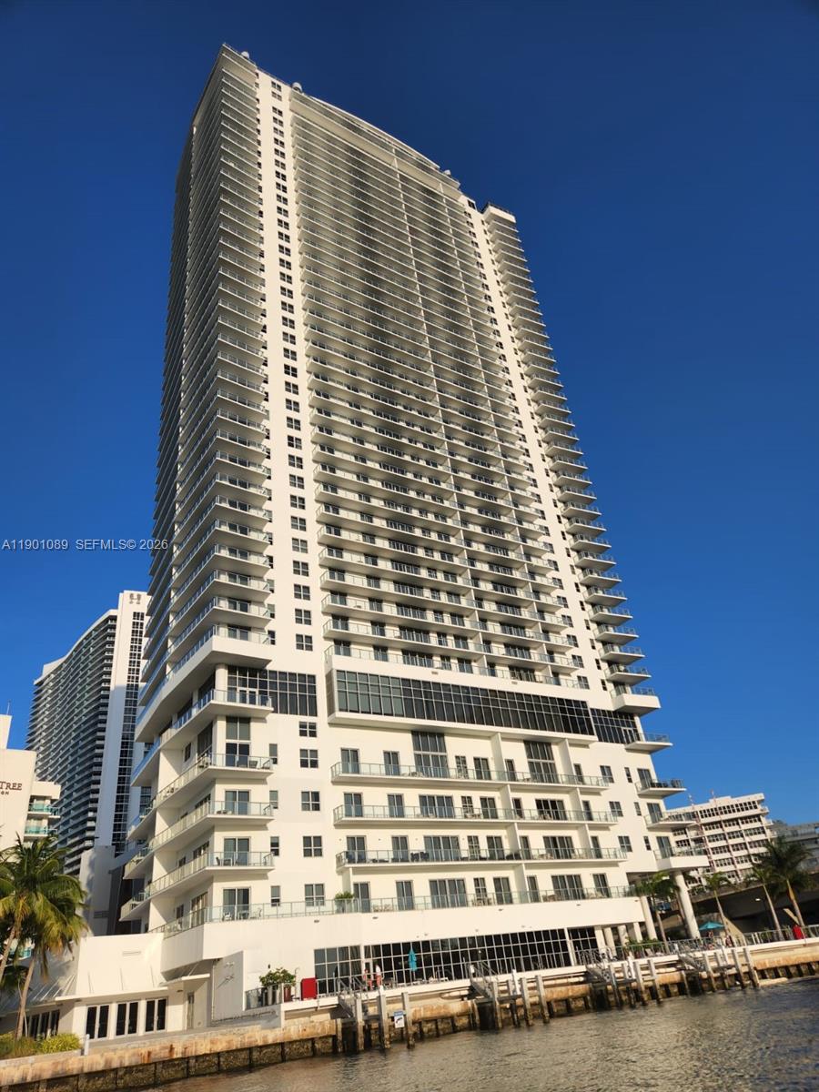A tall, modern white residential high-rise building stands next to a waterfront bulkhead — 4010 S Ocean Dr # R1709, Hollywood FL 33019, HOLLYWOOD, FL
