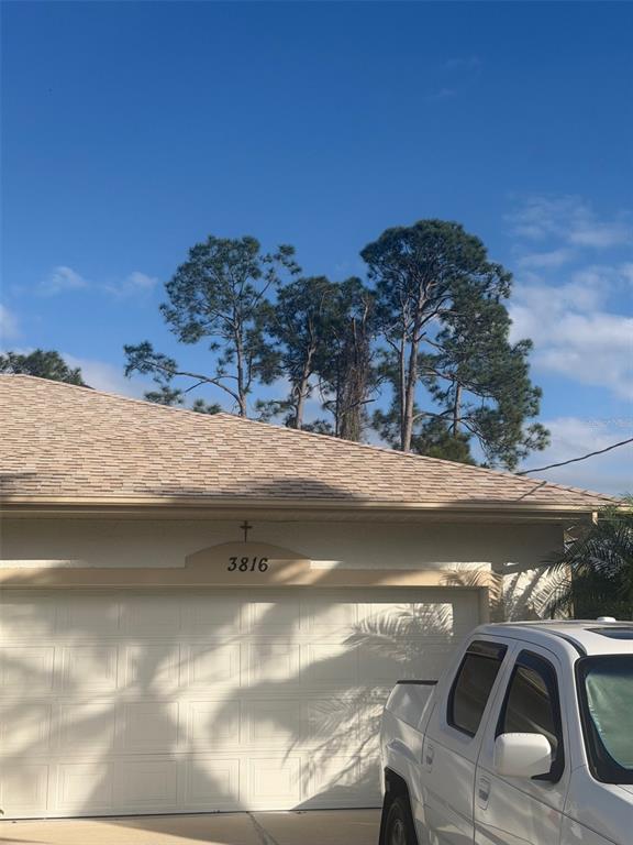 A white truck is parked in front of a house with a tan shingled roof — 3816 N CRANBERRY BOULEVARD, NORTH PORT, FL