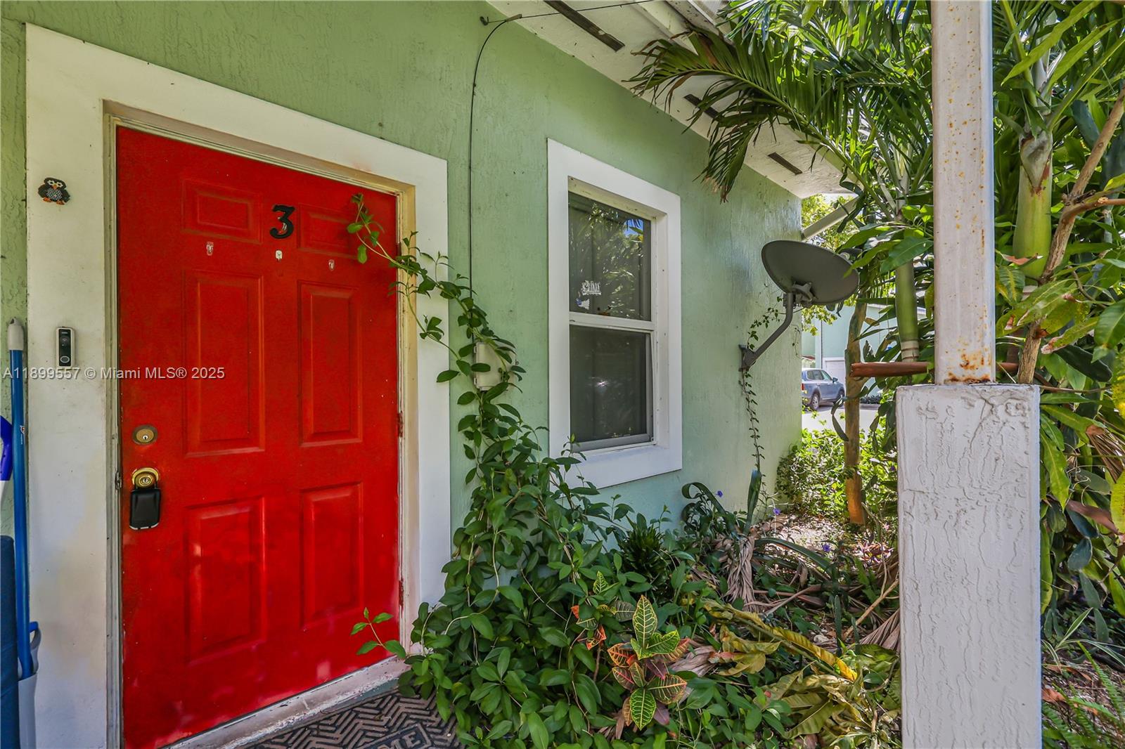 A bright red door marked with the number three sits on a light green exterior wall — 6960 NW 4th Ave # 3, Miami FL 33150, MIAMI, FL