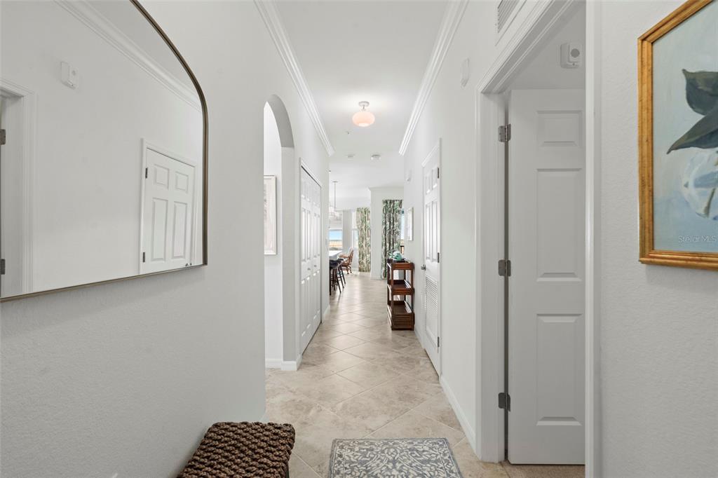 A bright hallway with tile flooring leads toward an open living area and kitchen — 14061 HERITAGE LANDING BOULEVARD UNIT 445, PUNTA GORDA, FL