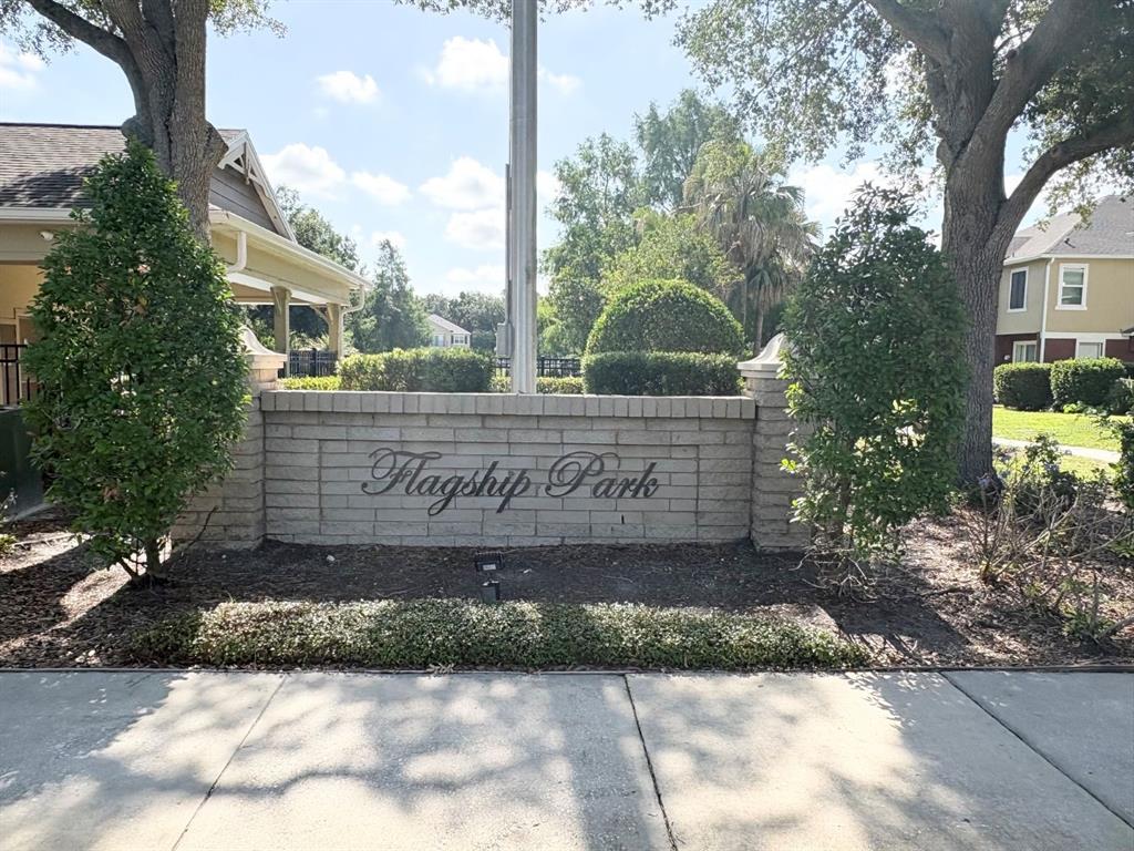 A brick entrance sign for Flagship Park stands between two trees on a sunny day — 1931 SAN JACINTO CIRCLE UNIT 1931, SANFORD, FL