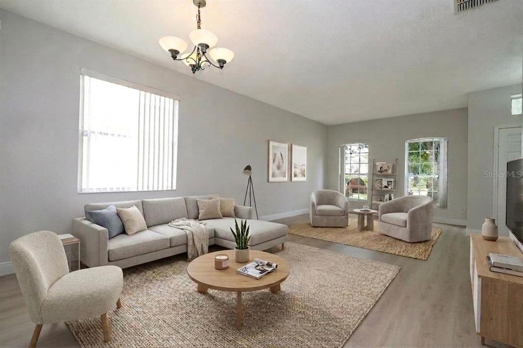 A bright living room features a sectional sofa, two armchairs, a coffee table, and rugs — 13827 HAWKEYE DRIVE, ORLANDO, FL