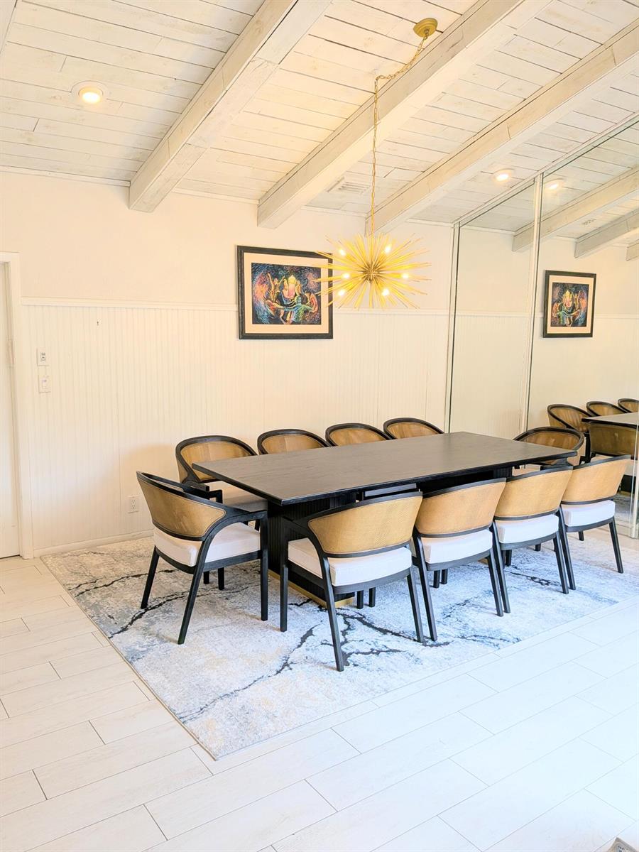 A dining room features a dark wood table, cane-back chairs, a starburst chandelier, and mirrors — 21089 Brookshire Terrace, Boca Raton FL 33433, BOCA RATON, FL