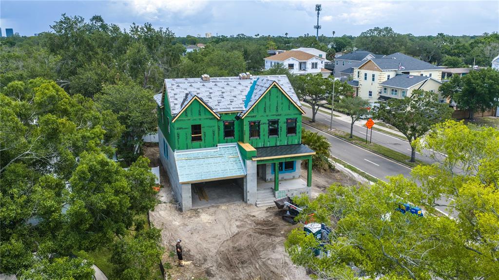 An aerial view of a two-story house under construction with green sheathing and roof underlayment — 3420 S GARDENIA AVENUE, TAMPA, FL