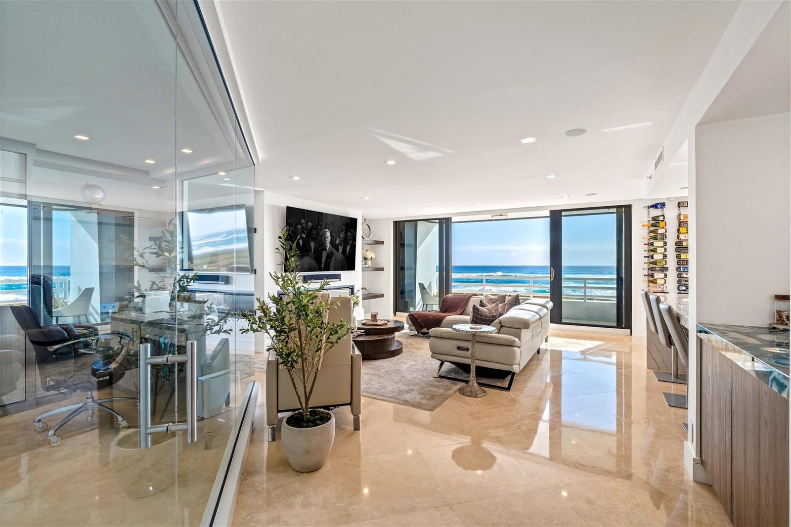 A modern living room with glass-enclosed office, marble floors, and a balcony overlooking the ocean — 1400 S Ocean Boulevard # 103, Boca Raton FL 33432, BOCA RATON, FL