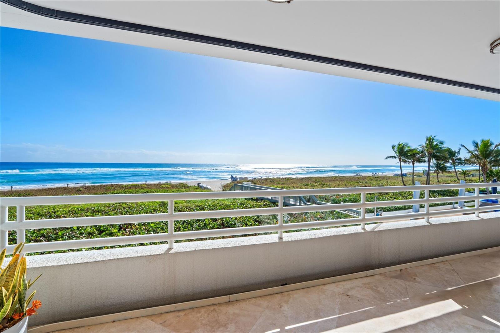 A balcony with a white railing overlooks a sandy beach and the ocean — 1400 S Ocean Boulevard # 103, Boca Raton FL 33432, BOCA RATON, FL