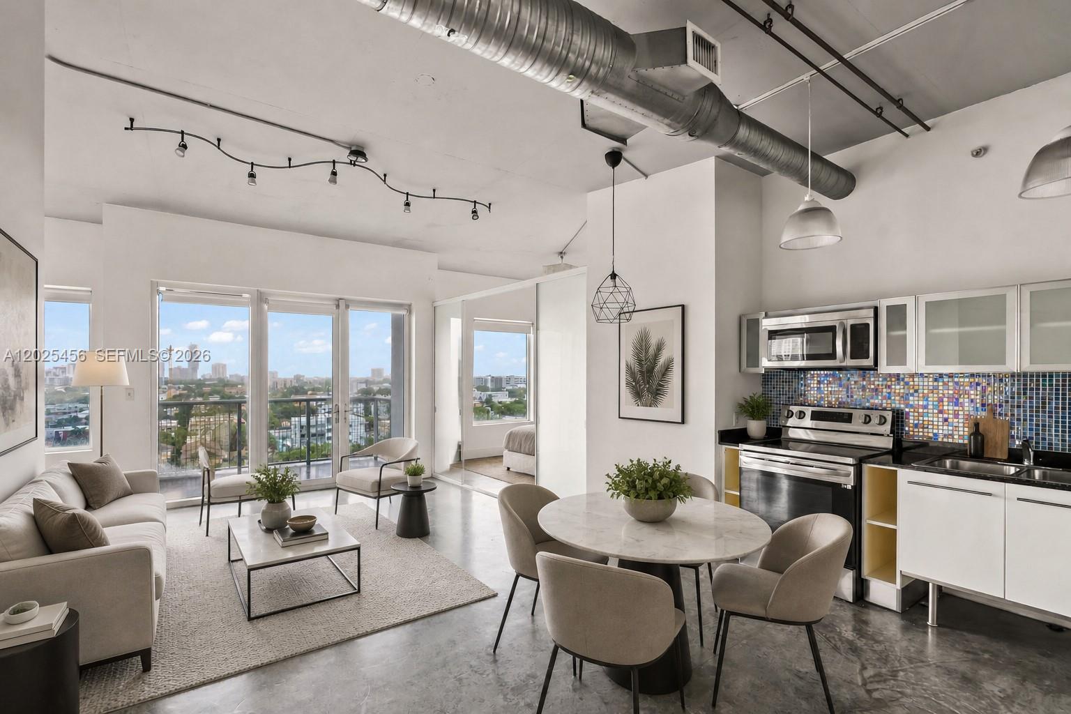 A modern open-concept living and dining area with concrete floors, exposed ductwork, and city views — 10 SW South River Dr # 1006, Miami FL 33130, MIAMI, FL