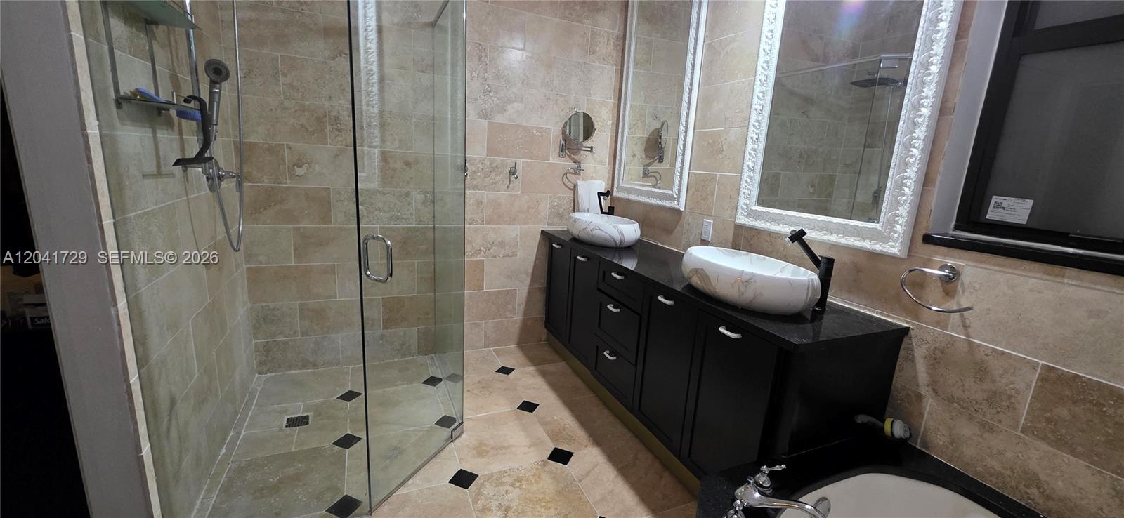 A bathroom features a glass-enclosed shower, a double vanity with vessel sinks, and tiled walls — 5010 Perignon Way, Coral Springs FL 33067, CORAL SPRINGS, FL