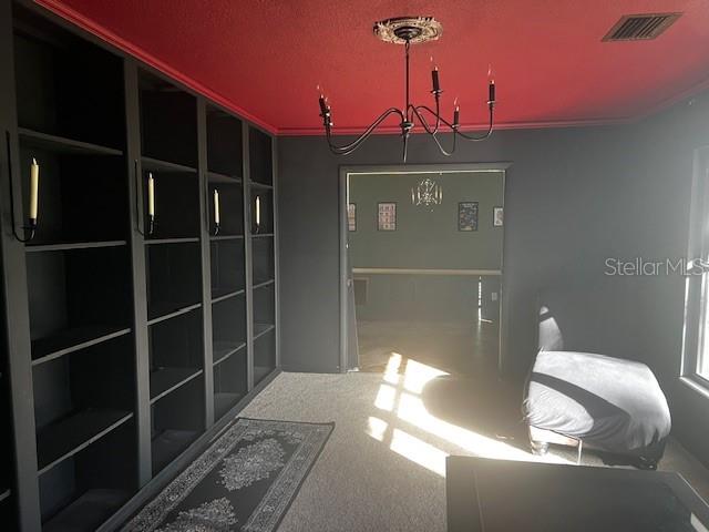 A room features dark built-in bookshelves, a red ceiling, a chandelier, and a lounge chair — 610 VALLE VISTA DRIVE, BRANDON, FL