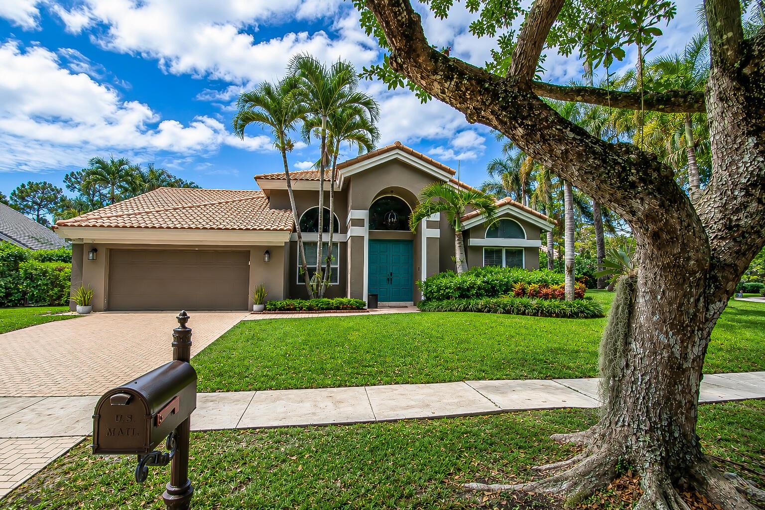A single-story house with a tile roof, teal front door, and a paved driveway — 2653 NW 46th Street, Boca Raton FL 33434, BOCA RATON, FL
