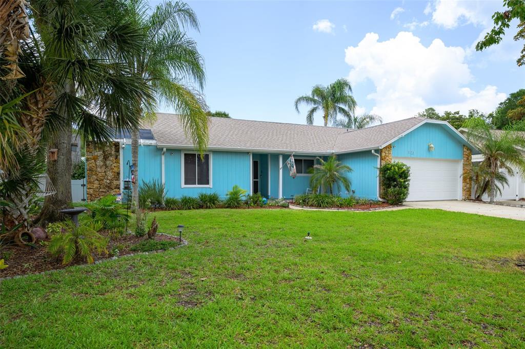A single-story blue house with a stone accent wall and a two-car garage — 1123 SHERBOURNE WAY, ORMOND BEACH, FL