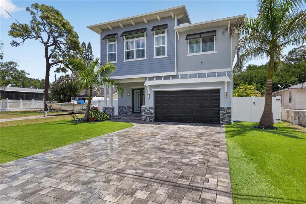 A two-story house with a paved driveway, a two-car garage, and palm trees — 6706 S STERLING AVENUE, TAMPA, FL