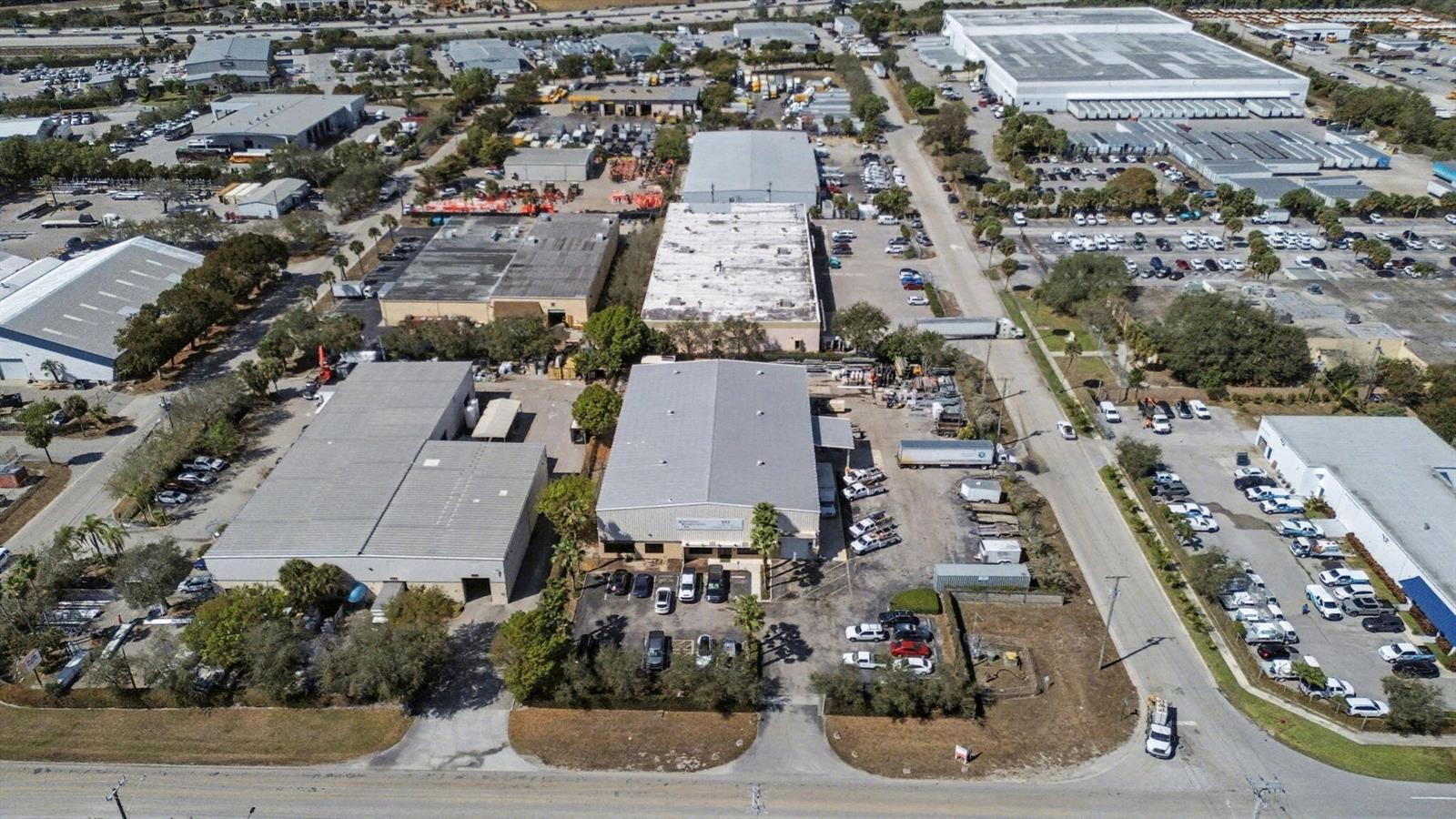 An aerial view shows several industrial warehouse buildings surrounded by parking lots and paved roads — 6861 Garden Road, Riviera Beach FL 33404, RIVIERA BEACH, FL